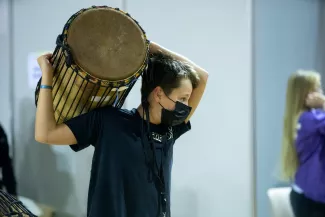 Junge tr&auml;gt eine Djembe